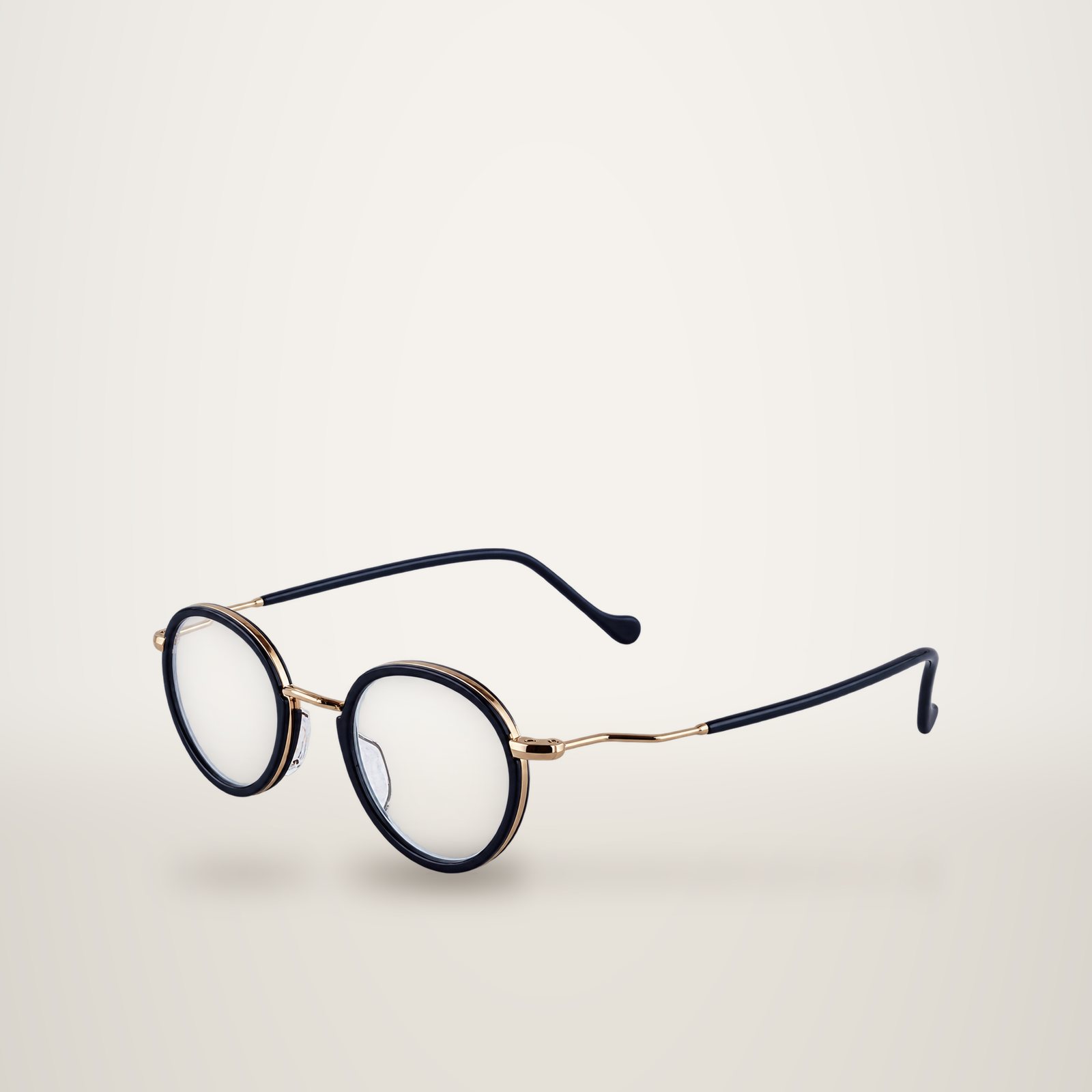 Paire de lunettes de vue rondes à monture bleu foncé et métal doré, présentée sur un fond uni clair.
